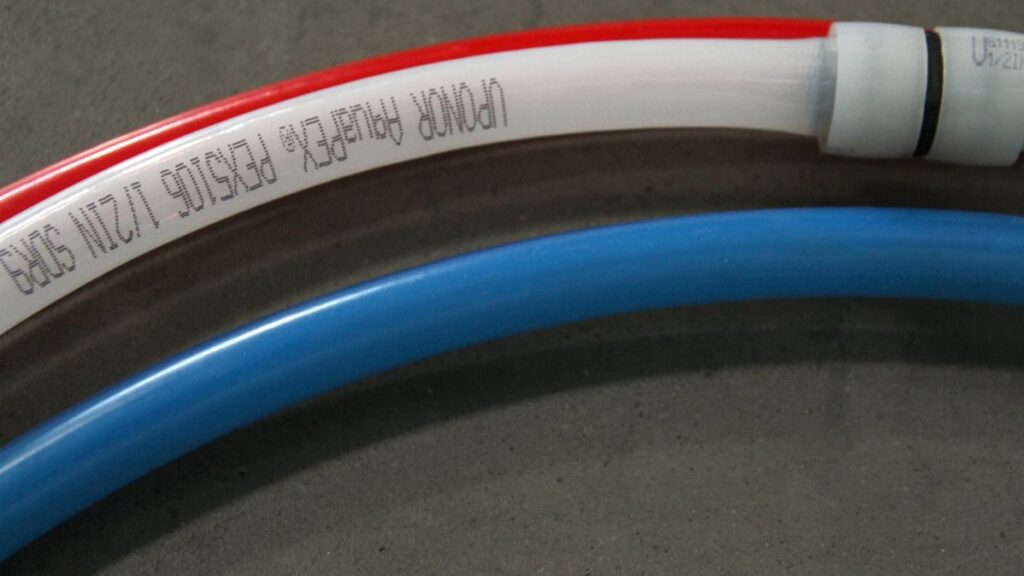 Close-up of new piping that replaces old, rusty pipes in a home, highlighting potential hazards and concerns for homeowners